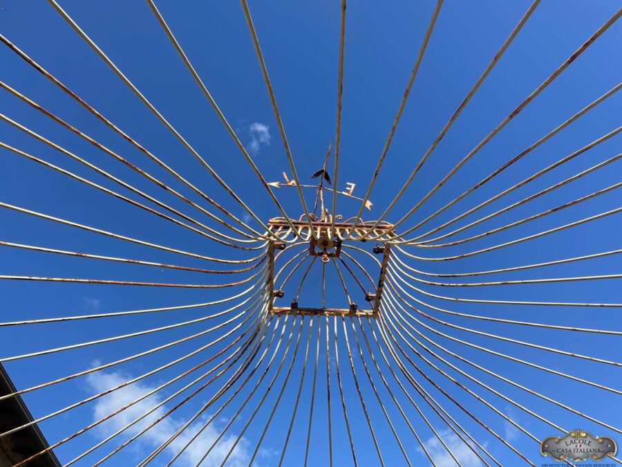 Handcrafted white iron gazebo, beautiful floral decorations and arched openings.
